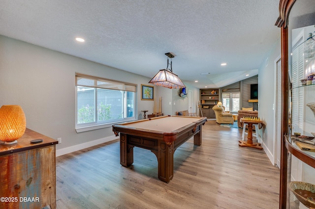 rec room featuring a wealth of natural light, pool table, lofted ceiling, and light wood-type flooring