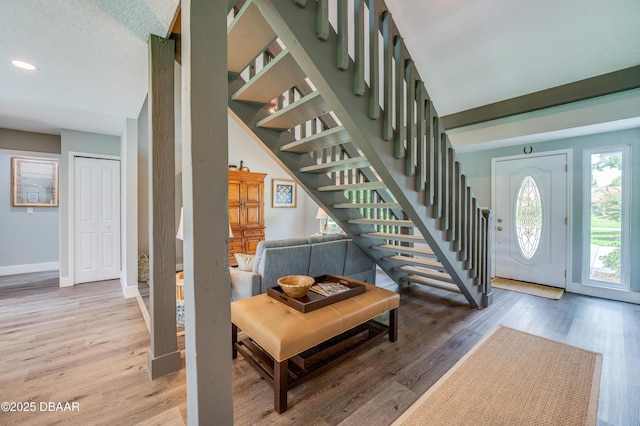 entrance foyer with a textured ceiling and wood-type flooring