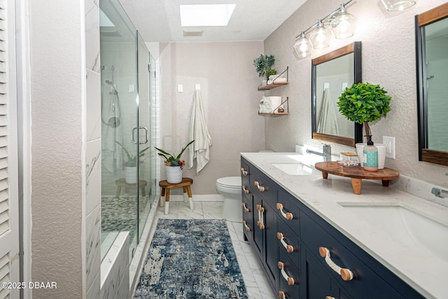 792 N Beach St, Ormond Beach, FL 32174 - bathroom featuring a skylight, double vanity, a shower stall, a textured wall, and marble finish flooring