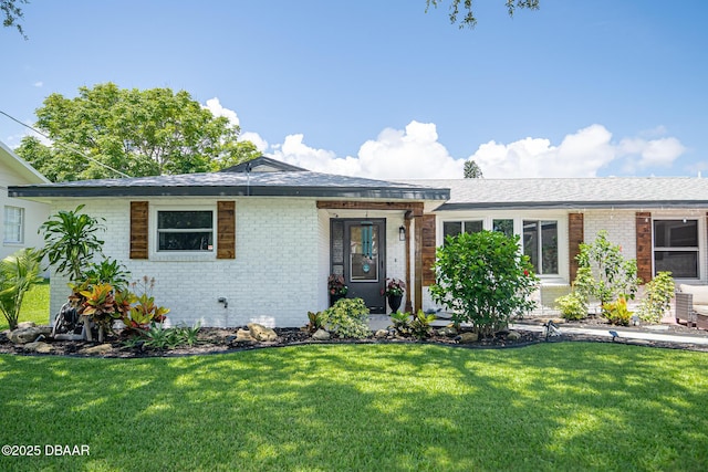 792 N Beach St, Ormond Beach, FL 32174 - ranch-style home featuring brick siding, a front lawn, and roof with shingles