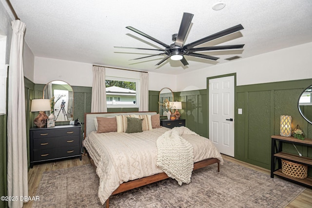 792 N Beach St, Ormond Beach, FL 32174 - bedroom with wood finished floors, ceiling fan, and a textured ceiling