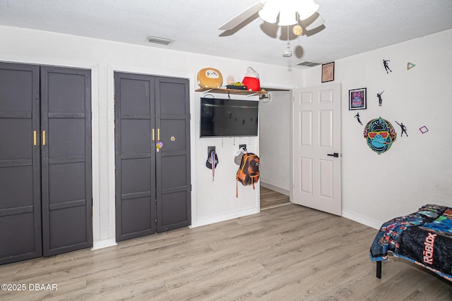 792 N Beach St, Ormond Beach, FL 32174 - bedroom featuring light wood finished floors, ceiling fan, and two closets