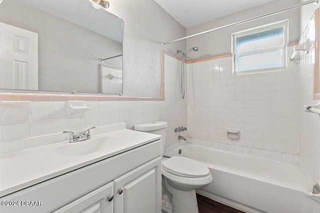 full bathroom featuring backsplash, vanity, tile walls, toilet, and tiled shower / bath