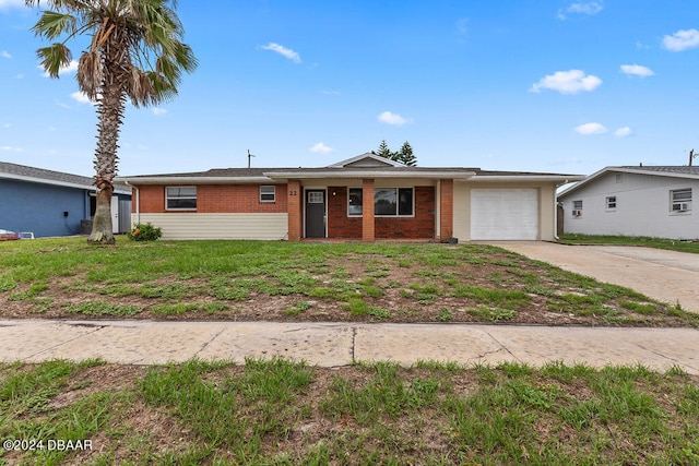 ranch-style house featuring a garage and a front yard