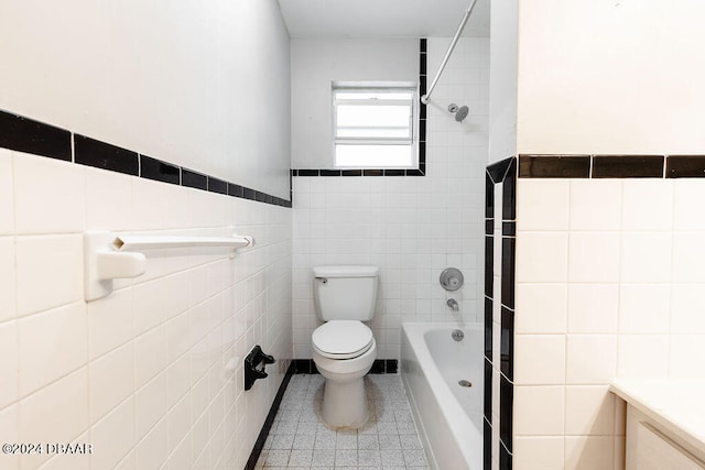 bathroom with tile patterned floors, tile walls, and toilet