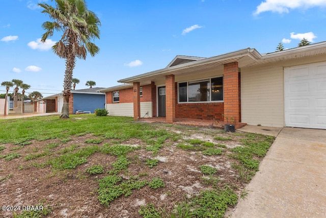 ranch-style house with a front lawn and a garage