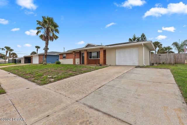 ranch-style house with a garage and a front lawn