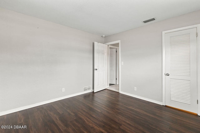 unfurnished bedroom featuring dark hardwood / wood-style flooring