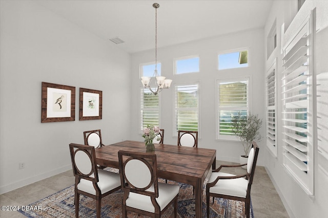 tiled dining space featuring a notable chandelier