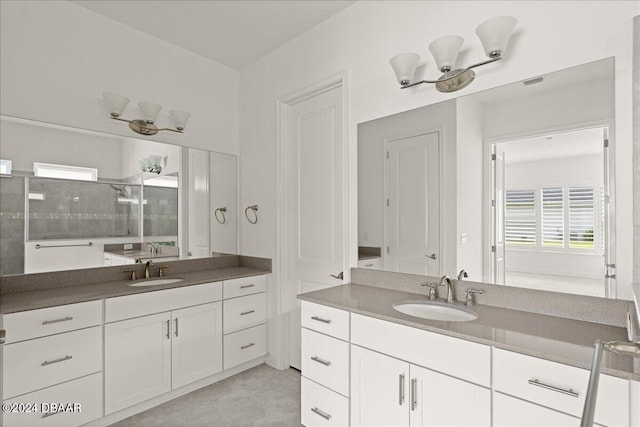 bathroom with walk in shower and vanity