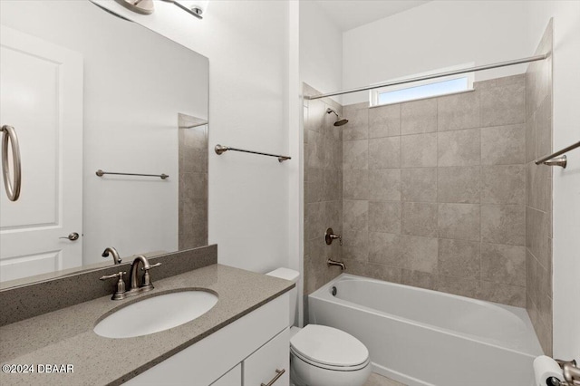 full bathroom with toilet, vanity, and tiled shower / bath