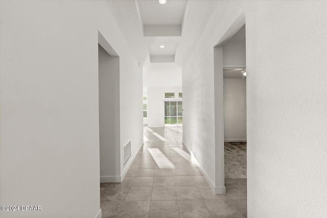 hallway featuring light tile patterned floors