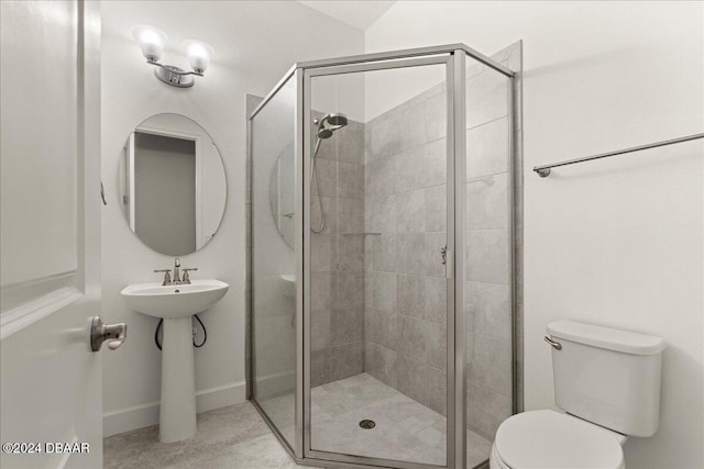 bathroom with toilet and a shower with shower door