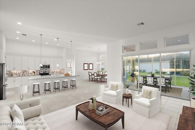 living room with an inviting chandelier and light tile patterned floors