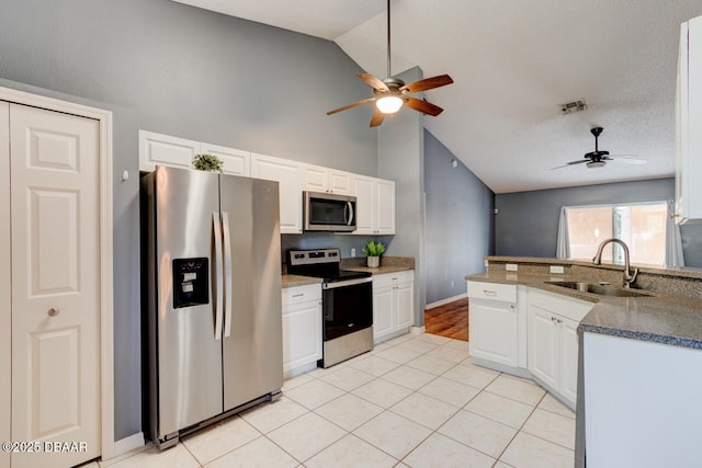 kitchen featuring appliances with stainless steel finishes, ceiling fan, white cabinets, and a sink