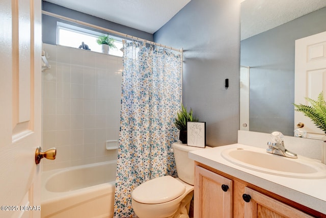 bathroom with shower / bath combo with shower curtain, toilet, and vanity