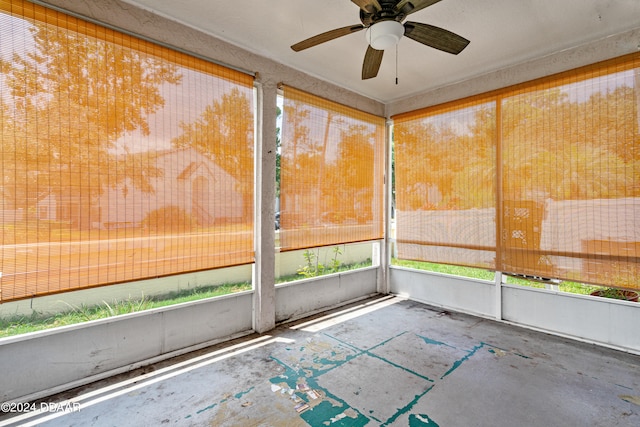 unfurnished sunroom featuring ceiling fan