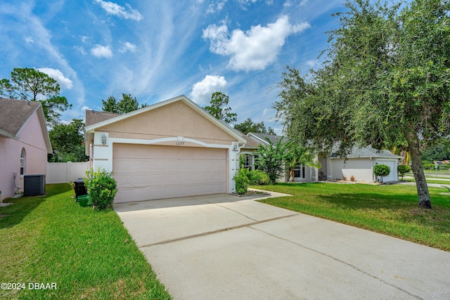 single story home with fence, concrete driveway, a front yard, central air condition unit, and stucco siding