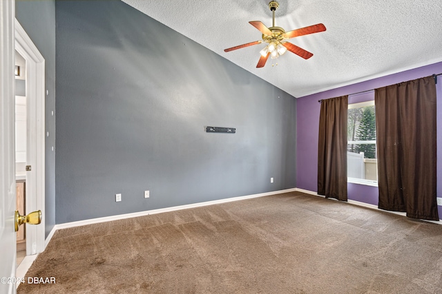 empty room featuring ceiling fan, light colored carpet, and a textured ceiling