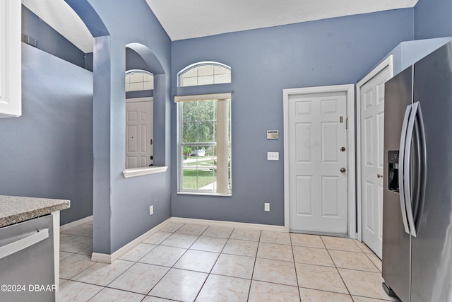 kitchen with stainless steel appliances and light tile patterned floors