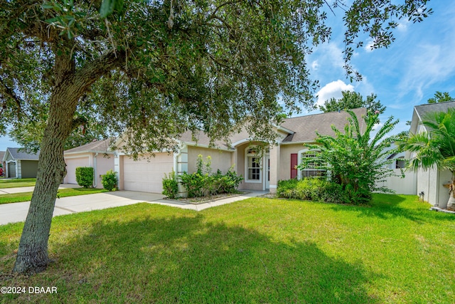 obstructed view of property with a front lawn and a garage