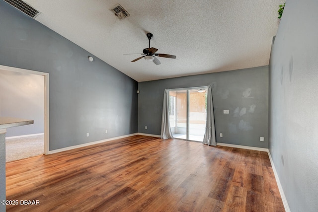 unfurnished room featuring visible vents, ceiling fan, a textured ceiling, and lofted ceiling
