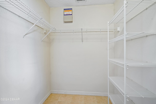 spacious closet with tile patterned floors