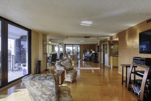 living room featuring expansive windows, hardwood / wood-style floors, and a textured ceiling