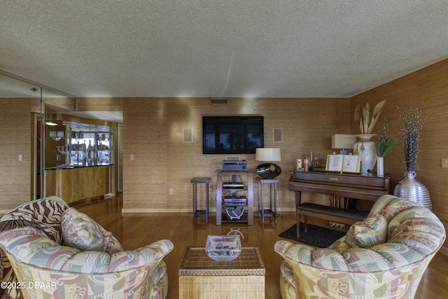 living room with hardwood / wood-style flooring and a textured ceiling