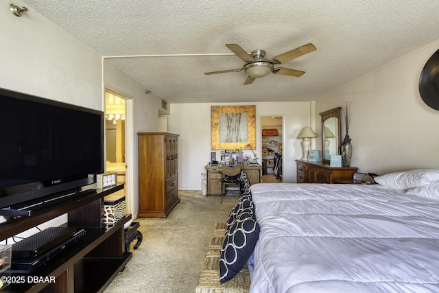 carpeted bedroom with ceiling fan and a textured ceiling