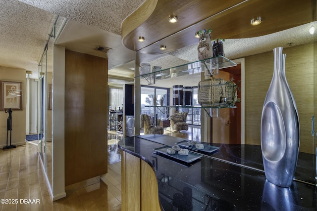 interior space with hardwood / wood-style flooring and a textured ceiling