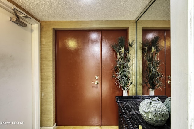 entryway with a textured ceiling