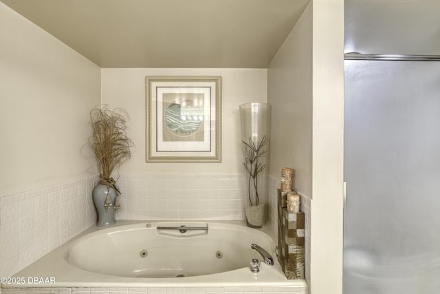 bathroom with a relaxing tiled tub