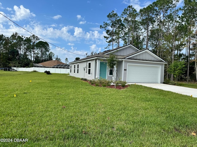 ranch-style house featuring a front yard and a garage