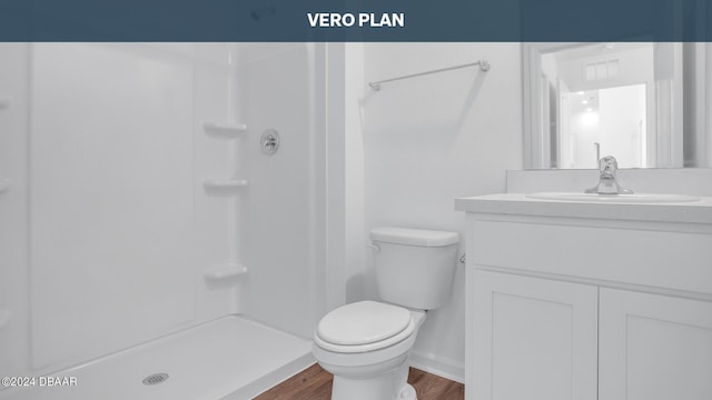 bathroom featuring vanity, hardwood / wood-style flooring, toilet, and walk in shower