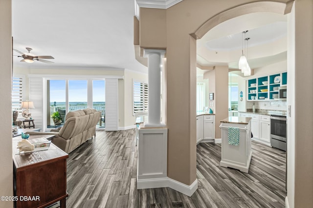 3737 S Atlantic Ave Unit 504, Daytona Beach Shores, FL 32118 - kitchen with appliances with stainless steel finishes, open floor plan, crown molding, a ceiling fan, and white cabinets