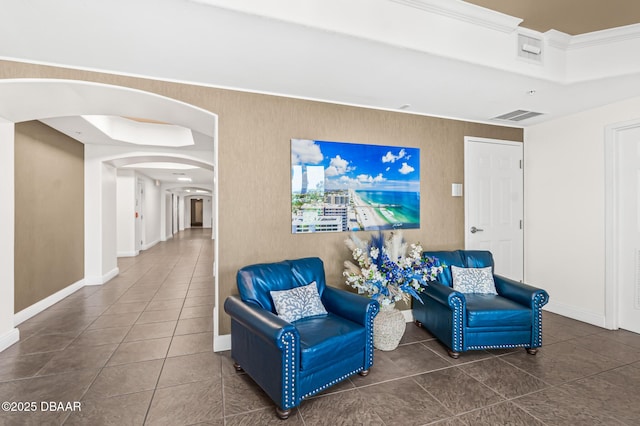 3737 S Atlantic Ave Unit 504, Daytona Beach Shores, FL 32118 - sitting room featuring arched walkways, tile patterned floors, baseboards, and crown molding