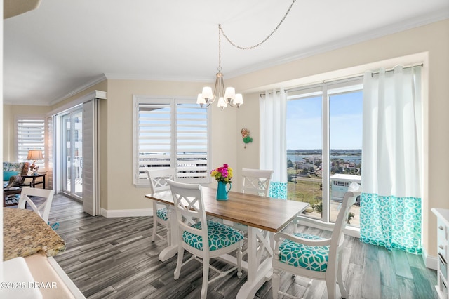 3737 S Atlantic Ave Unit 504, Daytona Beach Shores, FL 32118 - dining space featuring wood finished floors, baseboards, a chandelier, and ornamental molding