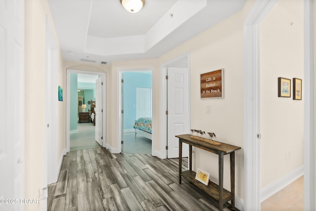 3737 S Atlantic Ave Unit 504, Daytona Beach Shores, FL 32118 - corridor with wood finished floors, a raised ceiling, and baseboards