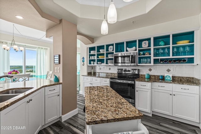 3737 S Atlantic Ave Unit 504, Daytona Beach Shores, FL 32118 - kitchen with stainless steel appliances, open shelves, a sink, dark wood-type flooring, and crown molding
