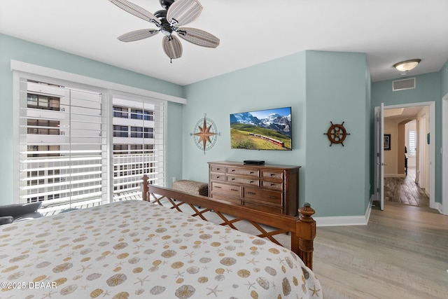 3737 S Atlantic Ave Unit 504, Daytona Beach Shores, FL 32118 - bedroom with baseboards, light wood-style floors, arched walkways, and ceiling fan