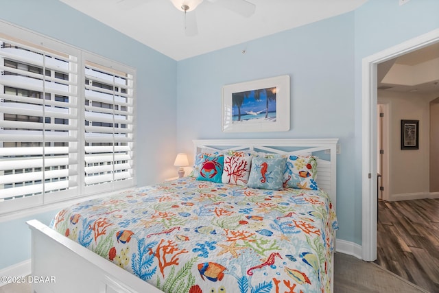 3737 S Atlantic Ave Unit 504, Daytona Beach Shores, FL 32118 - bedroom with baseboards, wood finished floors, and a ceiling fan