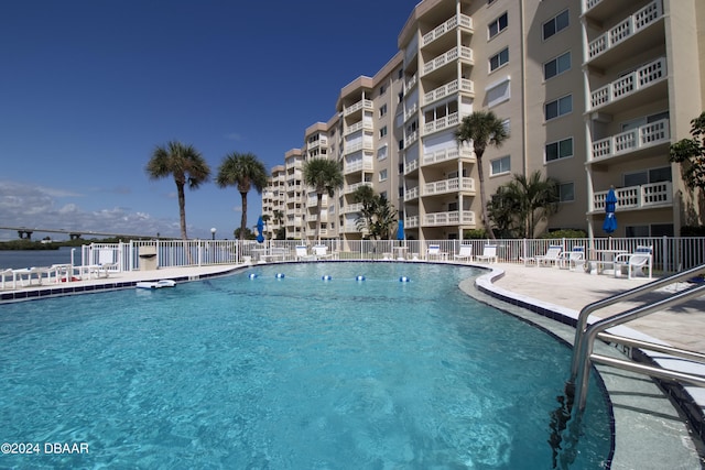 view of pool featuring a water view