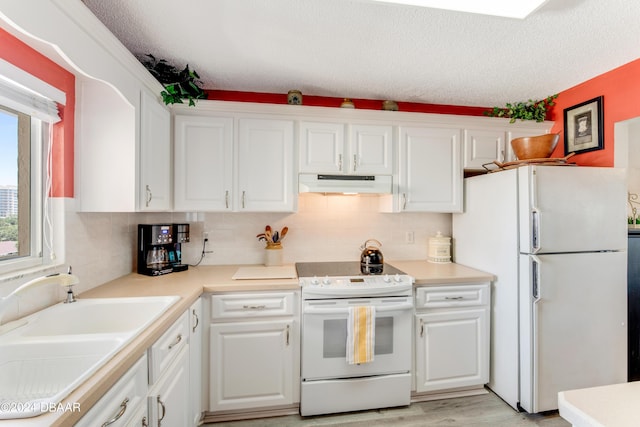 3606 S Peninsula Dr Unit 608, Port Orange, FL 32127 - kitchen with white appliances, under cabinet range hood, white cabinetry, a textured ceiling, and tasteful backsplash