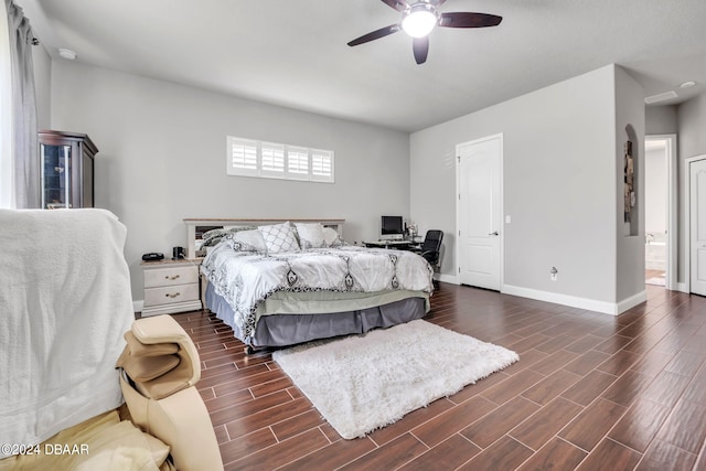 bedroom with ceiling fan, dark hardwood / wood-style floors, and ensuite bathroom