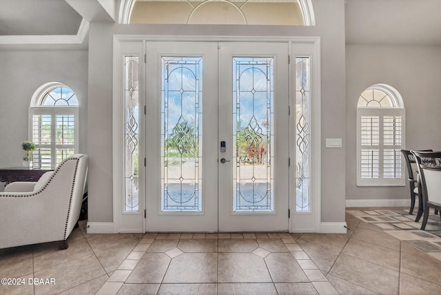 entryway featuring french doors and light tile patterned flooring