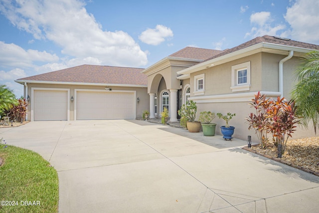 mediterranean / spanish-style home with a garage