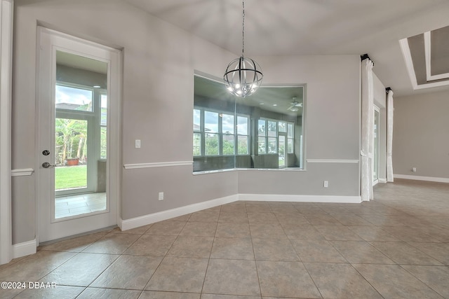 unfurnished dining area with a barn door, light tile patterned floors, and a notable chandelier