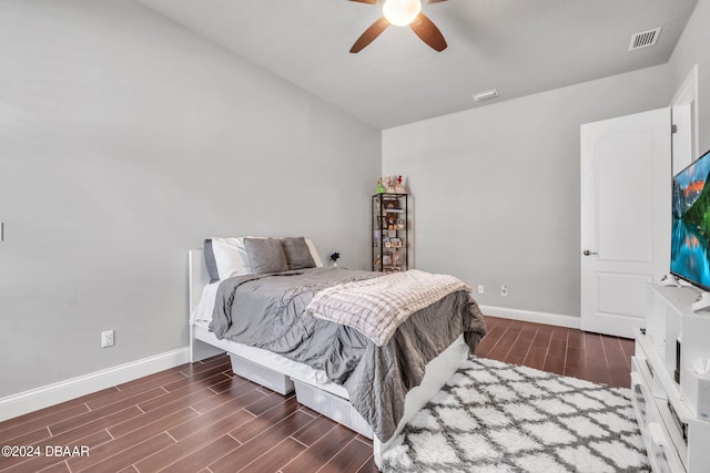 bedroom with dark wood-type flooring and ceiling fan