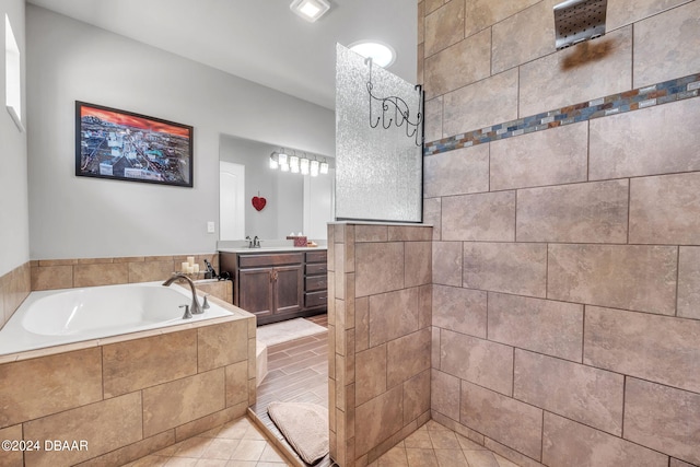 bathroom with shower with separate bathtub, vanity, and tile patterned floors